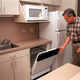 Roger Fisher, director of residential services, gives a tour of the kitchen complete with microwave, refrigerator, and a dishwasher at the Tom Brown/Pete Wright Residential Community on the campus of Texas Christian University in Fort Worth, Texas.